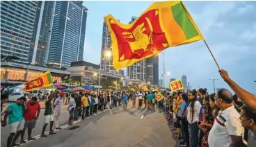  ?? (AFP) ?? Anti-government demonstrat­ors take part in a protest near the President's office in Colombo on Tuesday