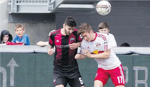  ?? ERROL MCGIHON ?? Ottawa Fury FC’s Chris Mannella collides with Benjamin Mines of New York Red Bulls II during their 0-0 draw Wednesday before a School Day crowd of 8,084 at TD Place.