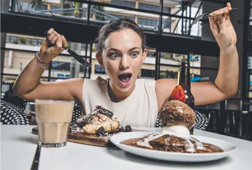  ?? Picture: JERAD WILLIAMS ?? Amy McIntyre tucks into a Nutella Calzone and Tella Balls from Salts Meat Cheese and Nutella latte from Paradox.