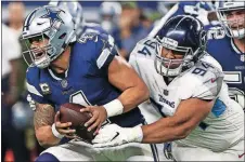  ?? [MICHAEL AINSWORTH/THE ASSOCIATED PRESS] ?? Titans nose tackle Austin Johnson (94) sacks Cowboys quarterbac­k Dak Prescott (4) during the second half Monday in Arlington, Texas.