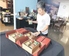  ?? — Bernama photo ?? Gila Goodness company co-founder Theresa Lam prepares Nasi Lemak granola for a Chinese New Year gift set.