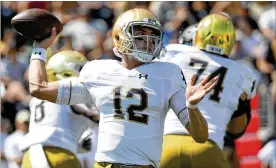  ?? STREETER LECKA / GETTY IMAGES ?? New Notre Dame quarterbac­k Ian Book helped the Fighting Irish more than double their previous season high for scoring and roll up a season-best 566 total yards in Saturday’s defeat of Wake Forest.