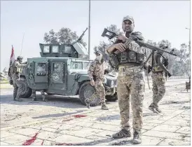  ?? MARTYN AIM / GETTY IMAGES ?? Iraqi troops come under fire Thursday as they advance on the Islamic State-occupied airport in Mosul. Despite being met with stiff resistance, Iraqi forces managed to seize most of the airport from jihadist fighters the same day.