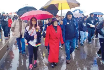  ?? MARLA BROSE/JOURNAL ?? Dolores Huerta, center, marches with family members, including Maya Tushka, front left, and Emilio Huerta, third from left, during the annual César Chávez Day march in Albuquerqu­e.