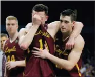 ?? DAVID J. PHILLIP — ASSOCIATED PRESS ?? Loyola-Chicago’s Ben Richardson and Clayton Custer, right, embrace after Saturday’s 69-57 loss to Michigan in San Antonio.