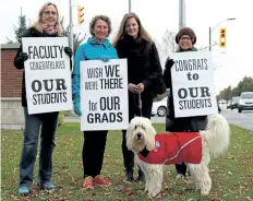  ?? LAURA BARTON/WELLAND TRIBUNE ?? Cooper the dog stands on the picket lines at Niagara College’s Welland campus with his owner and other college faculty members Friday during the continuing college strike. The faculty hold signs to show support for graduating students since they were unable to cross the picket lines to see them walk across stage.