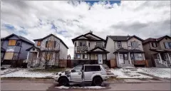  ?? CP PHOTO JEFF MCINTOSH ?? Residents survey the damage before beginning cleanup in Calgary on Sunday after a major hail storm damaged homes and flooded streets on Saturday.