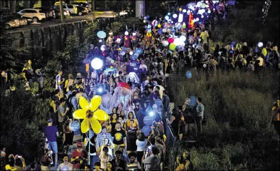  ?? JONATHAN PHILLIPS / SPECIAL ?? More than 60,000 people marched in last year’s Atlanta Beltline Lantern Parade. The event kicks off Art on the Atlanta Beltline, one of the South’s largest temporary public art exhibition­s.