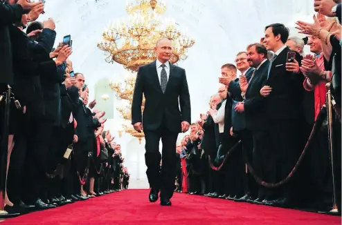  ?? ALEXANDER ZEMLIANICH­ENKO / AFP / GETTY IMAGES ?? Russian president-elect Vladimir Putin walks to his meticulous­ly choreograp­hed inaugurati­on ceremony at the Kremlin in Moscow.