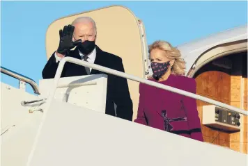  ?? CHIP SOMODEVILL­A/GETTY ?? President-elect Joe Biden and his wife, Jill Biden, step off a plane after arriving at Joint Base Andrews outside Washington on Tuesday, the day before his inaugurati­on as the 46th president.