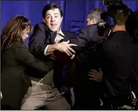  ??  ?? A man is forced
AP/RICK RYCROFT
off the stage in Sydney after Tony Abbott’s win in Australia’s election Saturday.