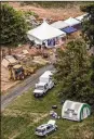  ?? AP ?? investigat­ors work under tents as they search for clues in the disappeara­nce of four men Thursday in Solebury, Pa.
