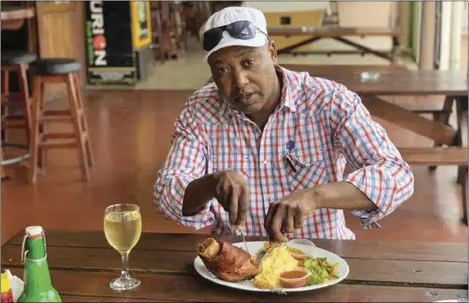  ??  ?? A customer eats a traditiona­l meal at Centurion Pub and Grill in Harare recently