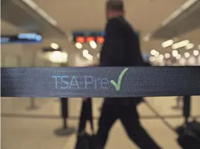  ??  ?? Travelers go through PreCheck at Miami Internatio­nal Airport. GETTY IMAGES