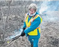  ?? ALEX LUPUL SPECIAL TO THE ST. CATHARINES STANDARD ?? Delland Trojan, a volunteer with the Friends of Malcolmson Eco-Park, assists during a controlled burn on Monday.