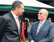  ?? CONTRIBUTE­D ?? With political knives drawn, but this time for eating, Prime Minister Andrew Holness (left) and Opposition Leader Peter Phillips have a hearty conversati­on before a hearty lunch on the lawns of Jamaica House, following the ceremonial opening of...