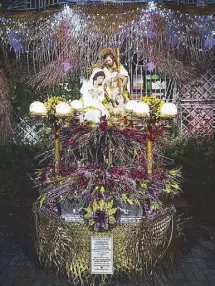  ??  ?? nay’s House Belen features the Holy Family on a converted caroza decorated with flowers and leaves.