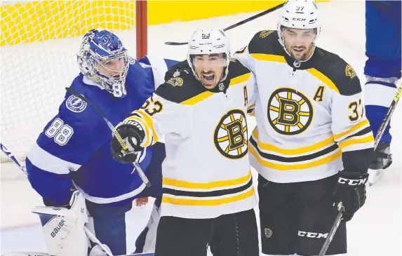 ?? JOHN E. SOKOLOWSKI/USA TODAY SPORTS ?? Bruins winger Brad Marchand, centre, says it’s a “luxury” to watch and play hockey, and protesting racial inequality is much bigger than sport.