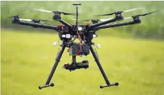  ?? AP ?? A hexacopter drone is flown during a demonstrat­ion at a farm and winery on the potential use for board members of the National Corn Growers, on Thursday, June 11, 2015, in Cordova, Maryland. Routine commercial use of small drones got a green light from...