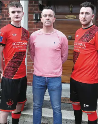  ??  ?? Drogheda United’s Thomas Byrne and Sean Brennan with Gary Kelly as United’s new centenary jersey is revealed at the Gary Kelly Cancer Support Centre.