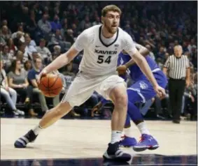  ?? GARY LANDERS — THE ASSOCIATED PRESS ?? Xavier’s Sean O’Mara (54) drives to the Delgado, rear, this week in Cincinnati. basket against Seton Hall’s Angel