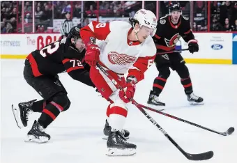  ?? SEAN KILPATRICK THE CANADIAN PRESS FILE PHOTO ?? Detroit Red Wings winger Tyler Bertuzzi skates with the puck as Senators defender Thomas Chabot tries to push him off it during NHL action in Ottawa on Monday. Bertuzzi has been dealt to the Boston Bruins.