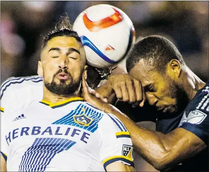  ?? RINGO H.W. CHIU/SP/PNG FILES ?? Vancouver Whitecaps defender Kendall Waston, right, battling for a header with Los Angeles Galaxy midfielder Sebastian Lletget, has been suspended for yellow card accumulati­on and will miss his team’s game Saturday against the New England Revolution.