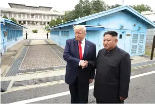  ?? (Kevin Lamarque/Reuters) ?? US PRESIDENT Donald Trump and North Korean leader Kim Jong Un meet at the Korean Demilitari­zed Zone yesterday.