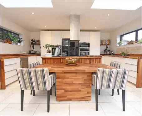  ??  ?? The dual aspect family kitchen (above) and cosy snug (top right) are two modern highlights in this traditiona­l red sandstone home