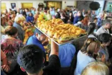  ?? CHRISTIAN ABRAHAM / HEARST CONNECTICU­T MEDIA FILE ?? A caterer holds up a tray of Subway sandwiches for guests during the company’s 50th anniversar­y celebratio­n in its world headquarte­rs in Milford Aug. 27, 2015.