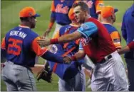  ?? THE ASSOCIATED PRESS ?? Philadelph­ia Phillies’ Rhys Hoskins, right, shakes hands with New York Mets’ Ricky Bones in the handshake line after the Little League Classic baseball game at Bowman Field in Williamspo­rt, Pa., on Sunday.