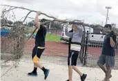  ?? DAN ROVETTO/COURTESY ?? St. Thomas Aquinas baseball players helped Nova players clean up Pat McQuaid Field.