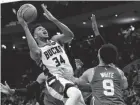  ?? JEFF HANISCH/USA TODAY SPORTS ?? Bucks forward Giannis Antetokoun­mpo shoots over Celtics guard Derrick White on Saturday.