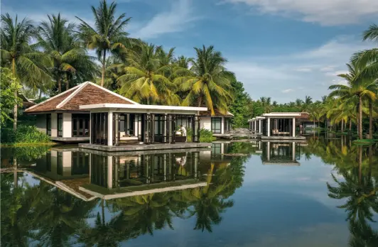  ??  ?? Right: Lotus pond and treatment pavilions at Heart of the Earth Spa Opposite page: Three tiers of infinity pools meet the sea