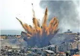  ??  ?? Smoke rises following Israeli airstrikes on a building in Gaza City on Thursday