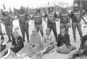  ?? PHOTO: Macjohn Akande ?? Members of the #BringBackO­urGirls group being prevented from protesting to the Presidenti­al Villa in Abuja recently