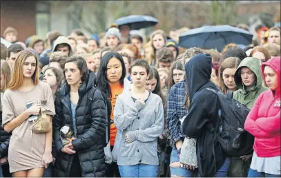  ?? [JONATHAN QUILTER/DISPATCH] ?? Hundreds of Upper Arlington High School students stand outside Wednesday as part of a 17-minute observance commemorat­ing the 17 people who lost their lives in the Parkland, Fla., shootings.