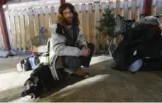  ??  ?? Jonathon Lawson and his dog, Chester, relax in a courtyard at St. Felix.