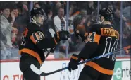  ?? THE ASSOCIATED PRESS FILE ?? Philadelph­ia Flyers’ Joel Farabee, left, and Sean Couturier celebrate after a goal against the Colorado Avalanche, Saturday in Philadelph­ia.