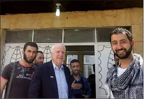  ?? AP file photo ?? Mouaz Moustafa (right), the executive director of the Syrian Emergency Task Force, is shown with Sen. John McCain (center) as they visit Syrian rebels in May 2013. Moustafa says his “letters of hope” effort was meant to show the people of war-torn...