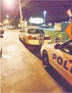  ?? — Reuters photo ?? Police cars are seen parked outside the scene of a shooting at the Cameo Nightlife club in Cincinatti.