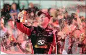  ?? LUIS M. ALVAREZ / AP ?? Tyler Reddick celebrates Saturday in Victory Lane after winning the NASCAR Xfinity Series championsh­ip at Homestead-Miami Speedway in Homestead, Fla.