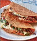  ?? STYLING BY KATE WILLIAMS / CHRIS HUNT FOR THE AJC ?? Coating the tortillas in reserved fat from the Birria de Res recipe is a key part of getting Quesabirri­a Tacos right.