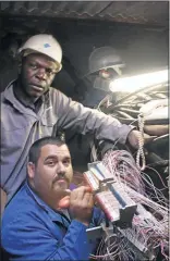  ?? PHOTO: JOE SEFALE ?? Telkom technician­s David Nkhanyaman­i and Spencer Engelbrech­t replace stolen cables in this file picture.