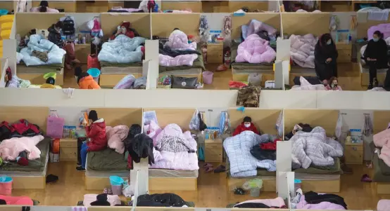  ??  ?? Patients with mild symptoms rest in a makeshift hospital used to treat novel coronaviru­s victims in Wuhan. — Xinhua