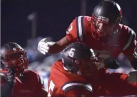  ?? PETE BANNAN — DIGITAL FIRST MEDIA ?? Upper Dublin’s Bryan Derr (66) and Jason Scott (13) embrace Dylan Zlotnikoff (5) after his second-quarter touchdown reception against West Chester Rustin Friday night.