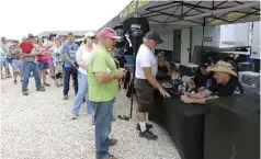  ??  ??  A couple of fast Pro Street diesel trucks square off to battle as the stands fill with eager spectators.  At the dragstrip, Farm Truck and Jeff Lutz of Street Outlaws took time out from preparing their race vehicles to sign autographs and spend time...