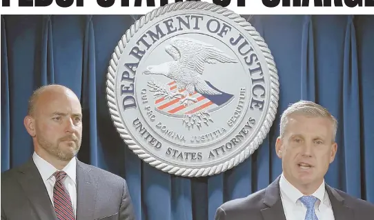  ?? STAFF PHOTO BY ANGELA ROWLINGS ?? ‘BEGINNING AND NOT THE END’: U.S. Attorney Andrew E. Lelling listens as FBI Special Agent in Charge Harold H. Shaw speaks yesterday.