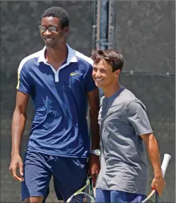  ?? Katharine Lotze/The Signal ?? West Ranch doubles partners Quincy Walter-Eze, left, and Noah Morrow smile during a tennis match at the Foothill League prelims at the Paseo Club on Wednesday.