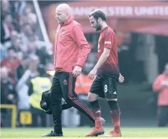  ?? | EPA ?? MANCHESTER United’s Juan Mata, right, leaves the field after picking up an injury against Liverpool at Old Trafford this past weekend. Mata is in doubt for tonight’s clash against Crystal Palace.